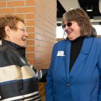 Lynn Blue laughing with a guest at the Lynn M. Blue Connection Naming Ceremony